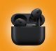 Matte black true wireless Bluetooth earbuds resting inside compact charging case